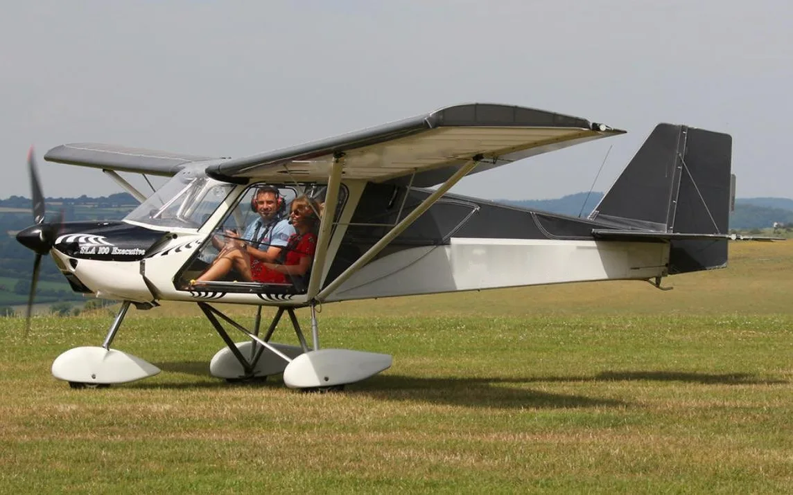 SLA 100 Executive lightweight aircraft parked on a grass airfield